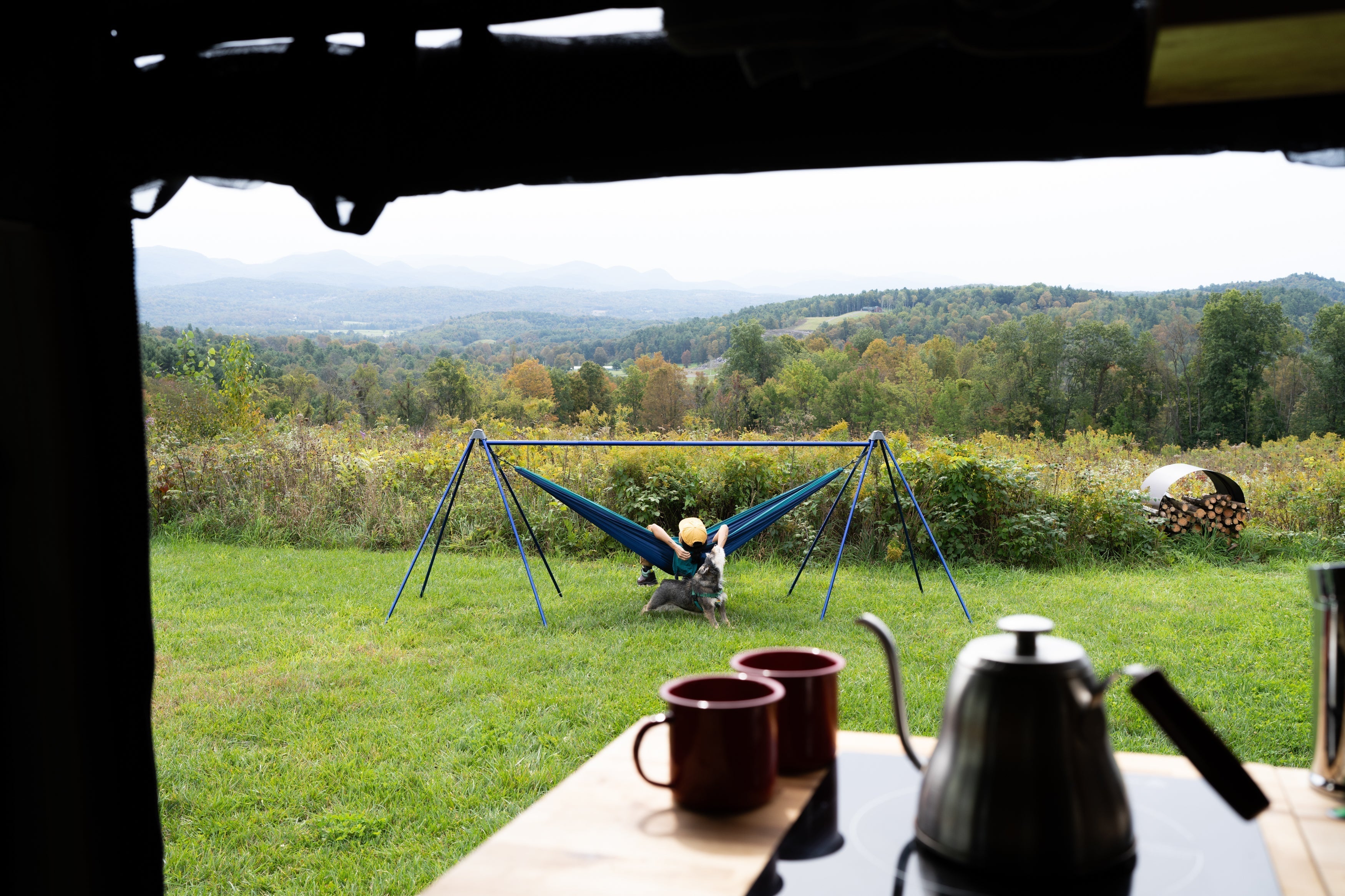 A person in an ENO hammock on the ENO Nomad Hammock Stand looking at mountains