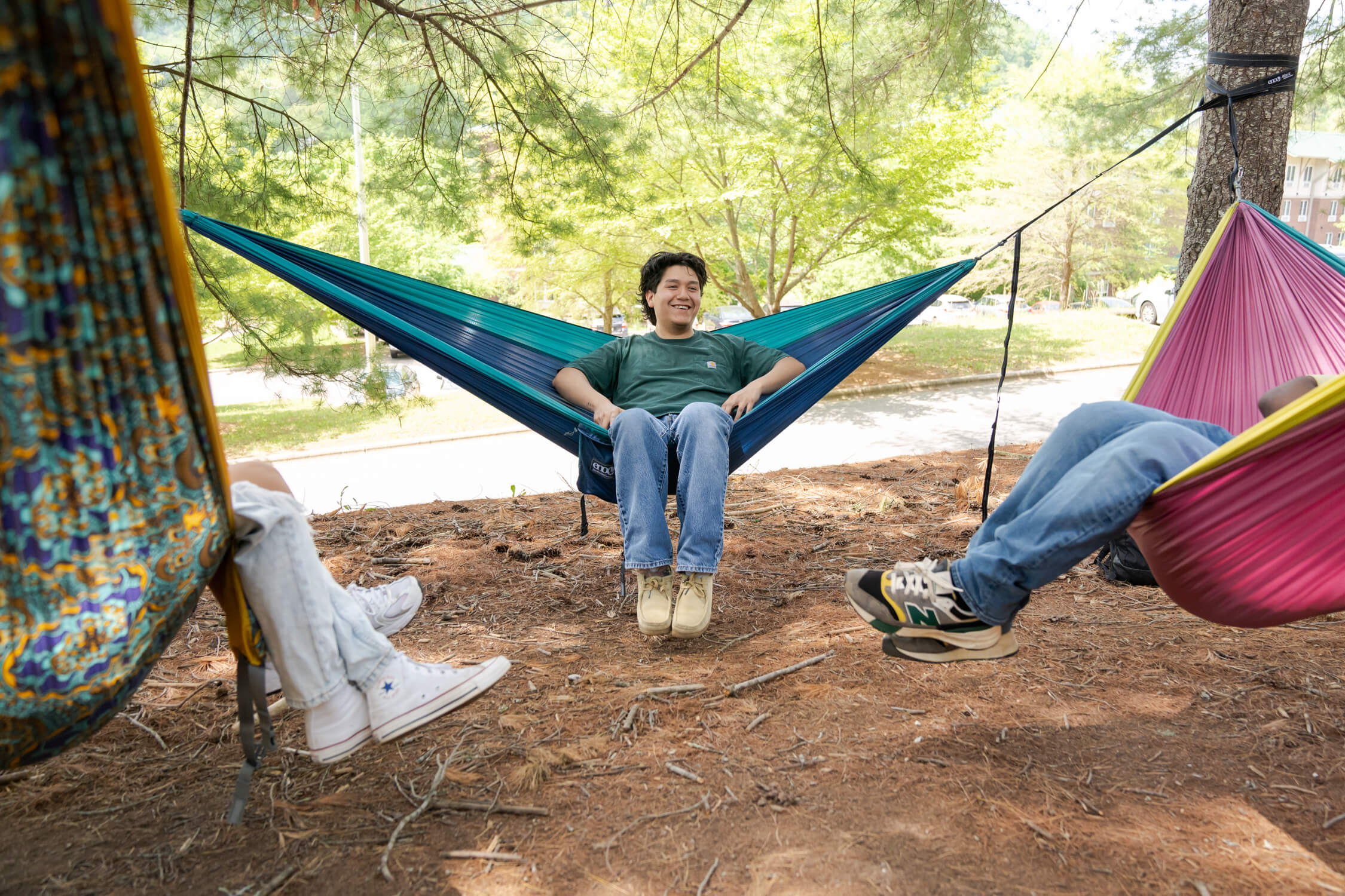 A college group of friends hammocking in ENO hammocks together