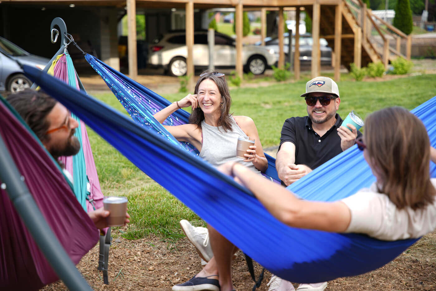 A group of friends hang out in hammocks on an ENOpod at the Lazy Tiger Hostel in Asheville, NC