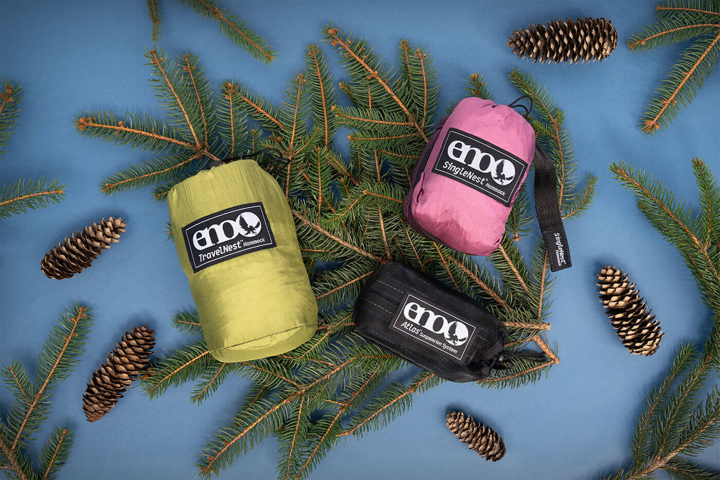 Three ENO gear on some evergreen tree branch surrounded by pine cones