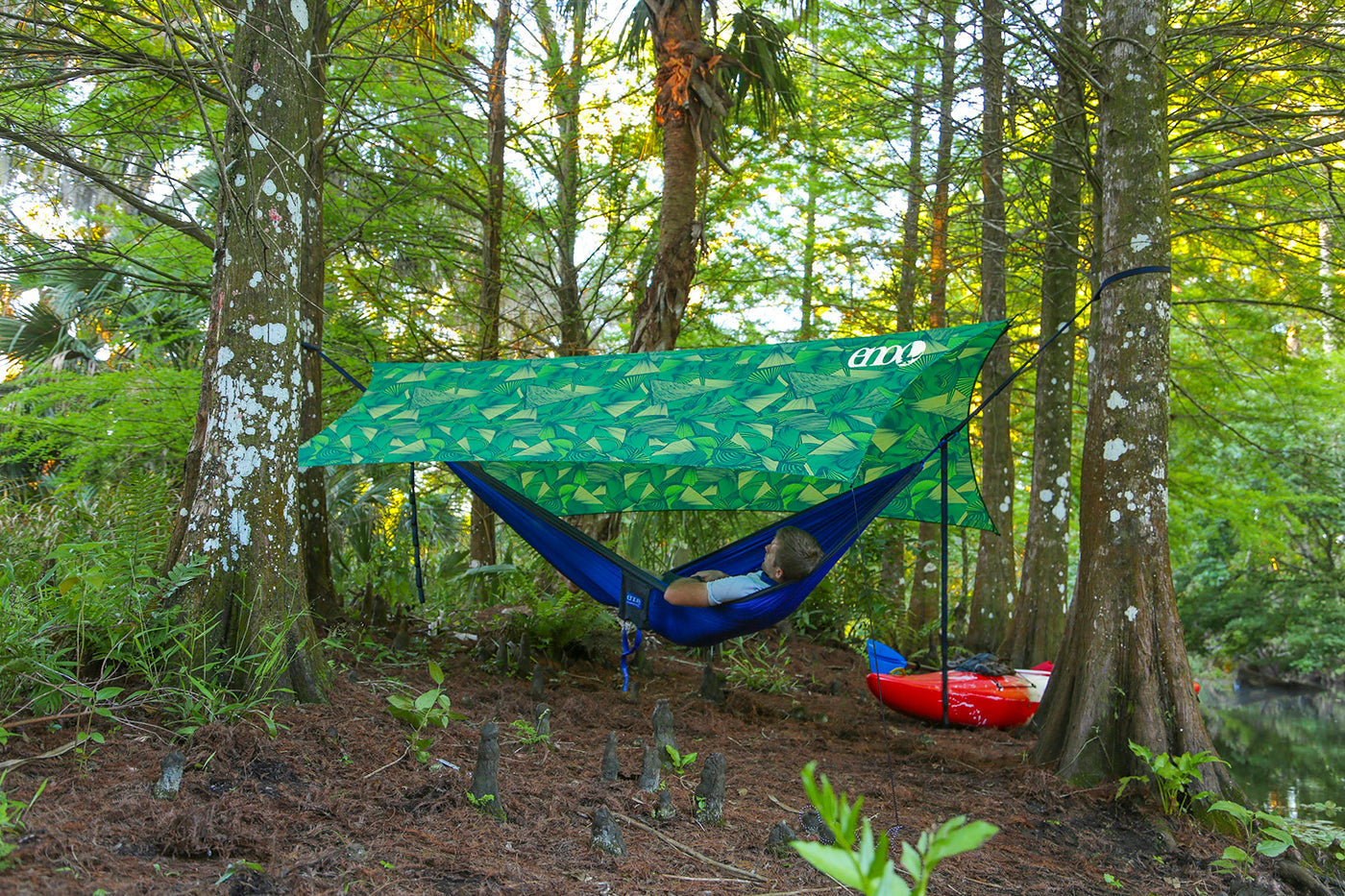 ENO hammock hanging under an ENO tarp in the woods