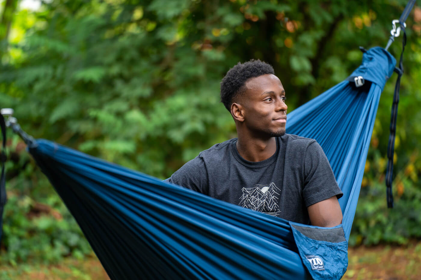 Nathaniel Flowers looking to our right while sitting in an ENO hammock