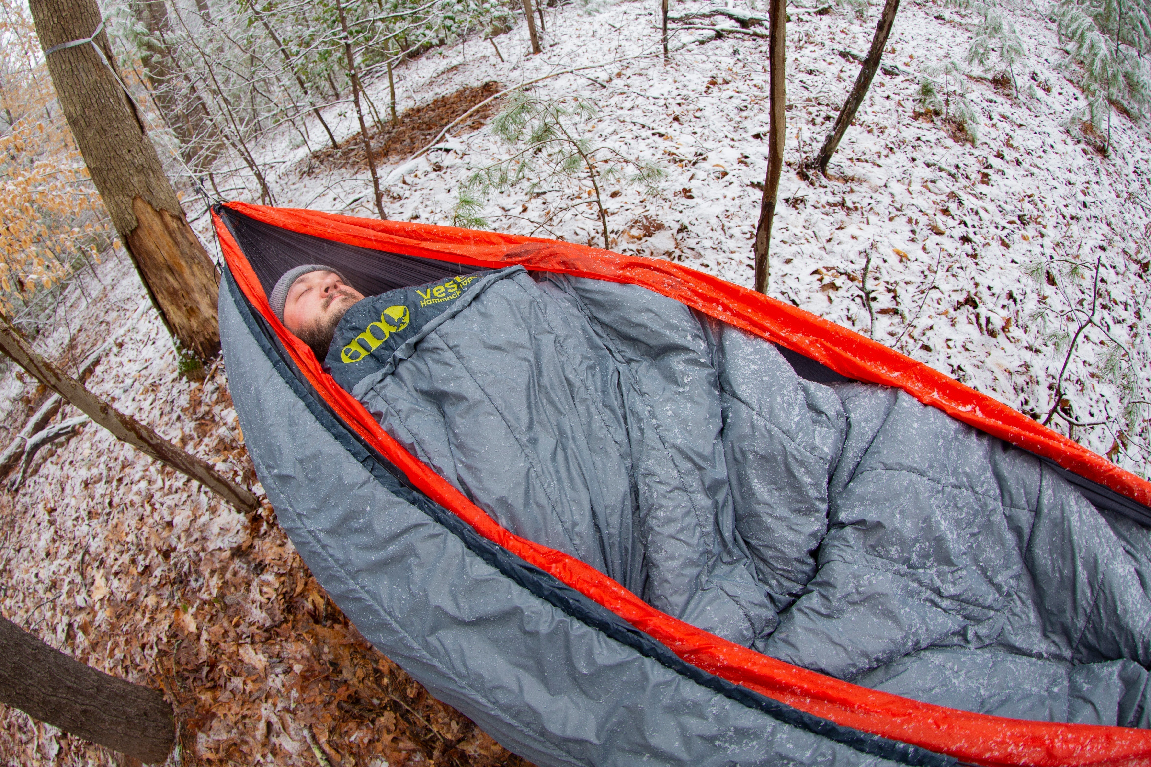 A man asleep in his ENO hammock with an ENO top and under quilt