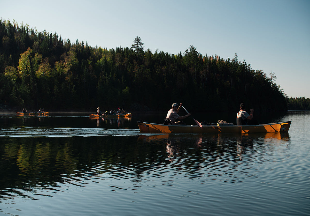 A group of people canoeing in a lake
