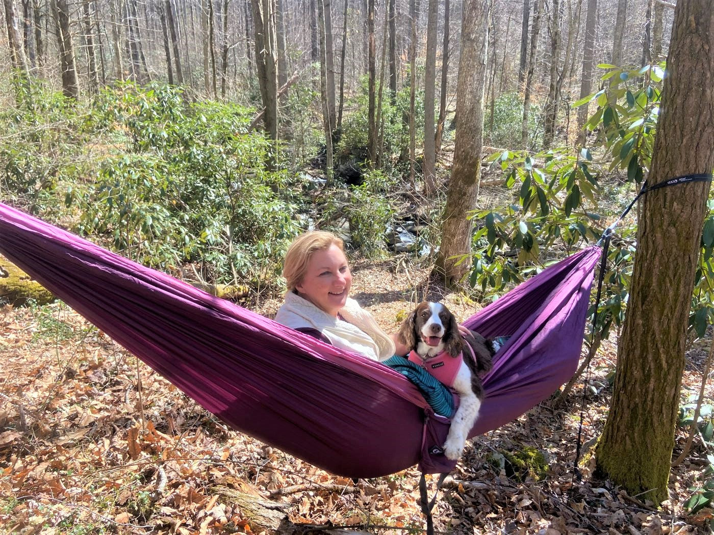 Woman and her dog hang in ENO DoubleNest hammock in WNC woods.