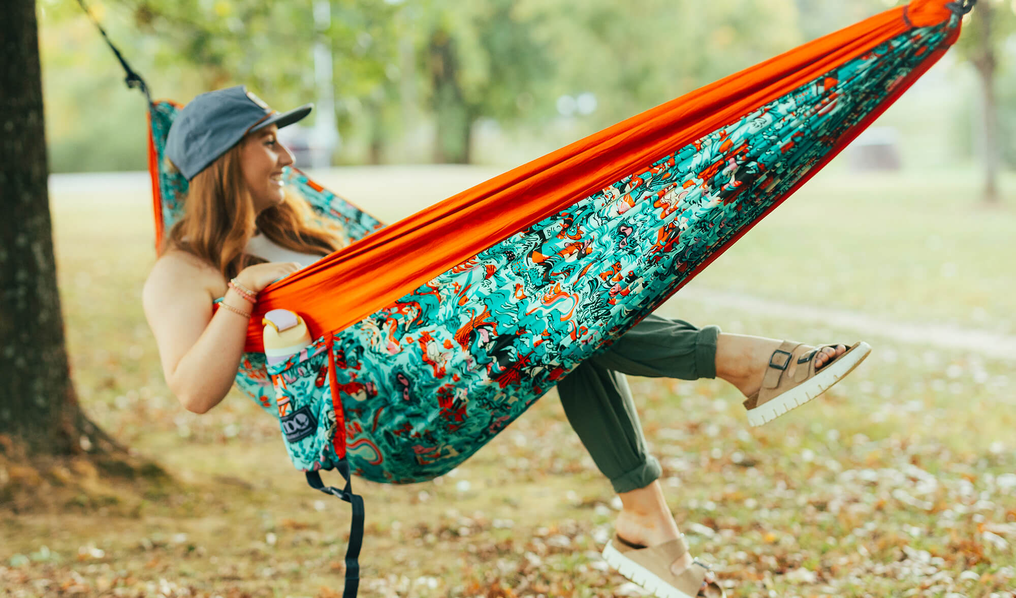 Person relaxing in the ENO In Good Company Giving Back Hammock in a park