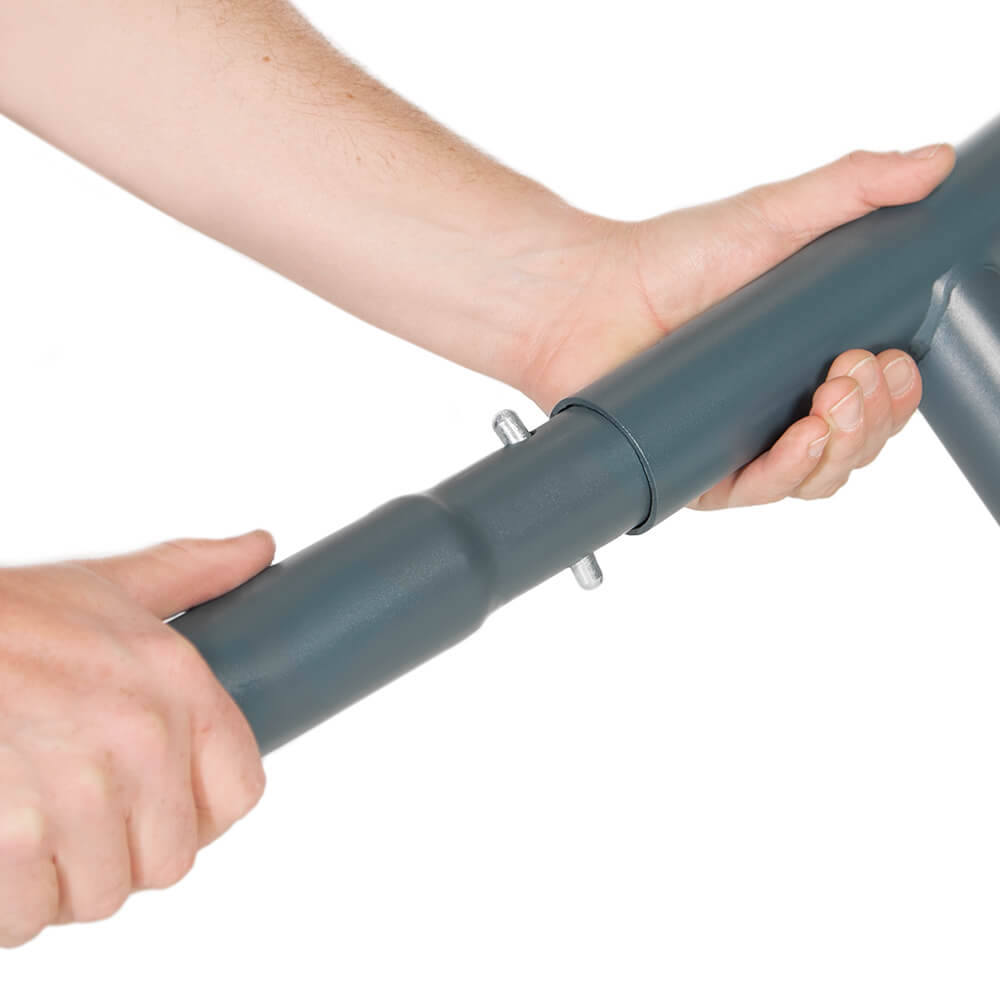 Detail studio photo depicting a person connecting the tubing for the SoloPod Hammock Stand.