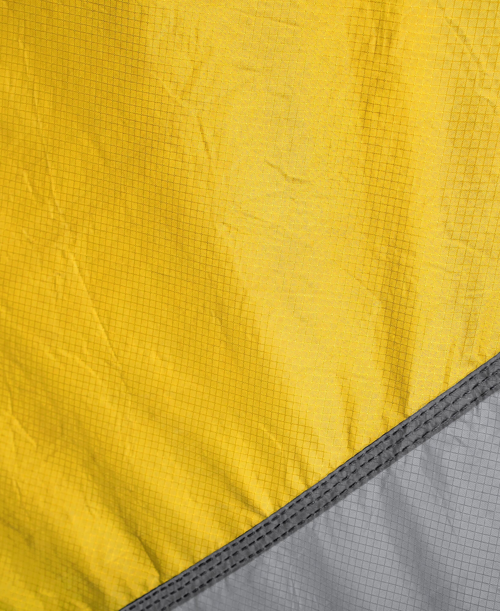 Close-up of yellow and gray fabric with a grid pattern