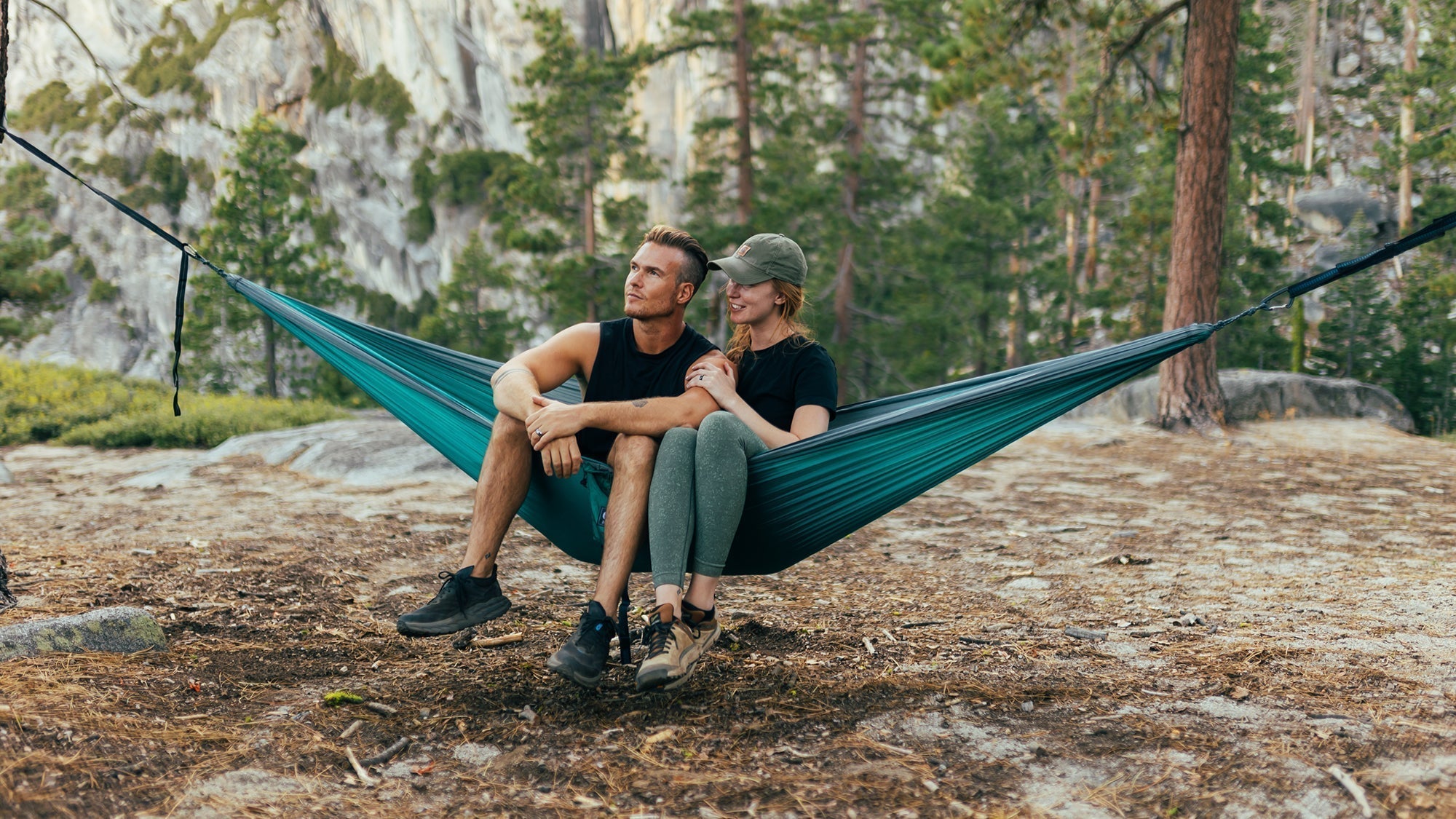 A couple shares an ENO DoubleNest Hammock in Yosemite