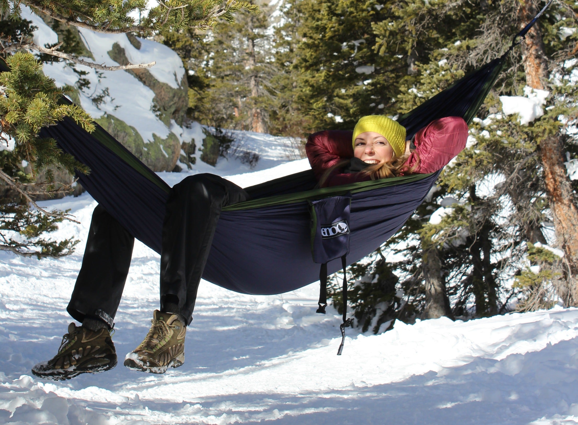 woman relaxing in hammock in the snowy Rocky Mountain National Park forest