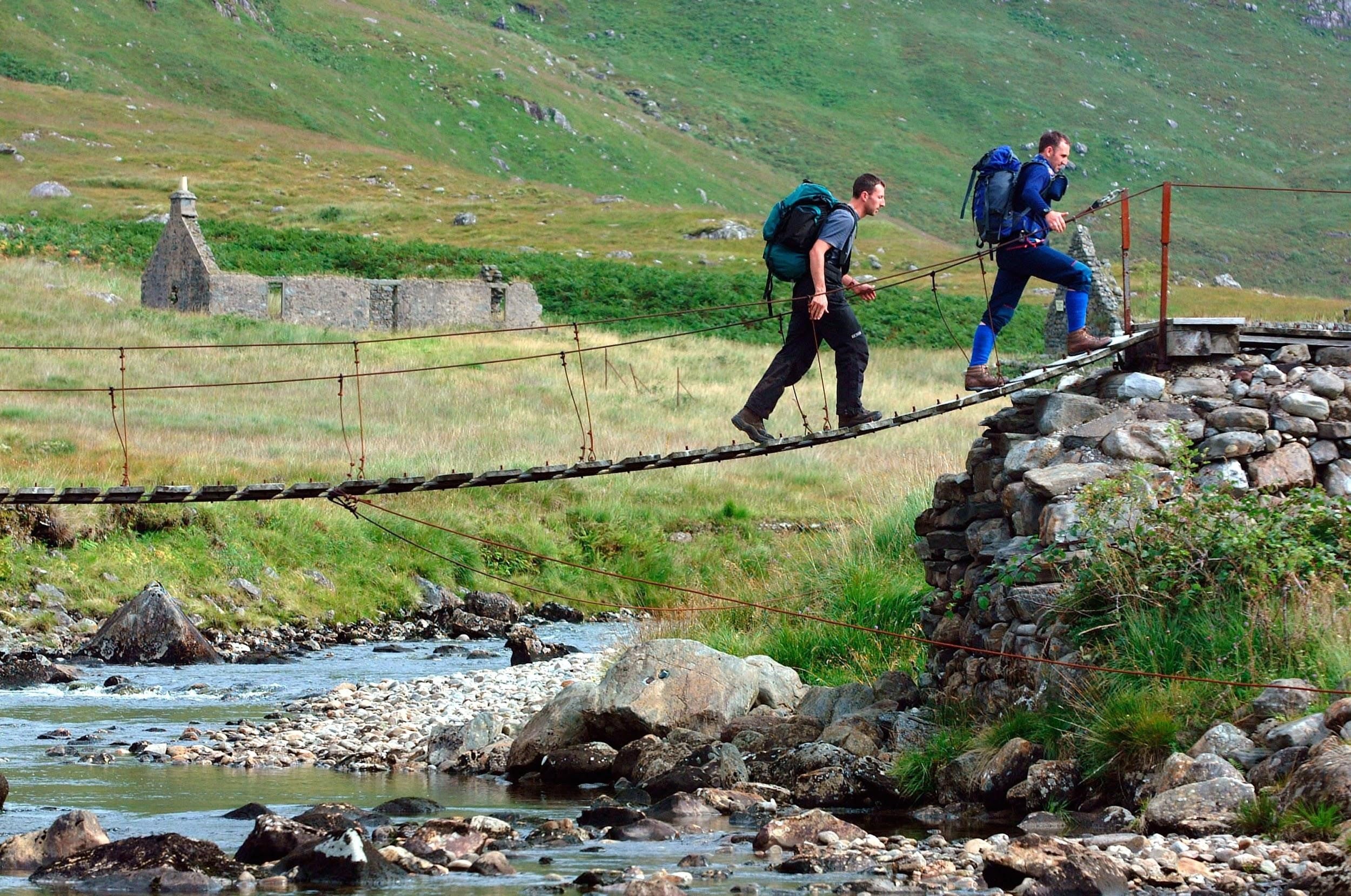 Hiking across a bridge in Scotland