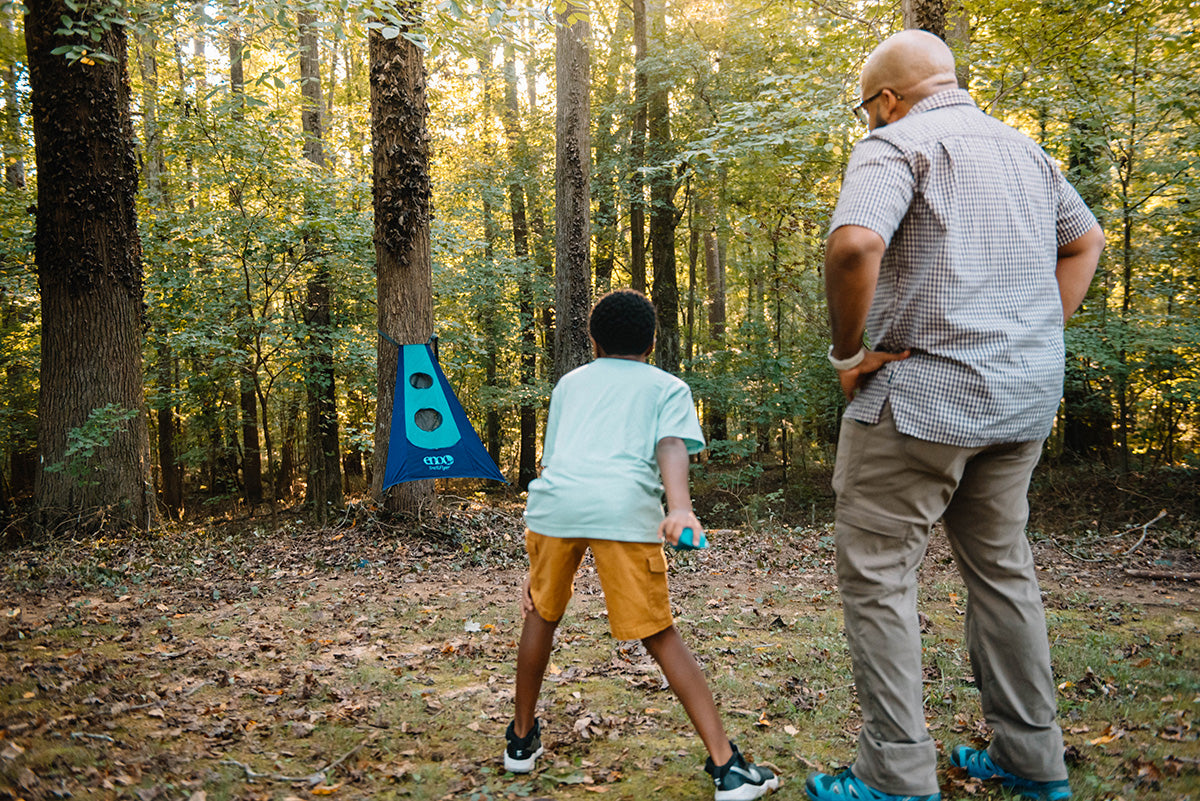 family playing the ENO trail flyer game in the woods