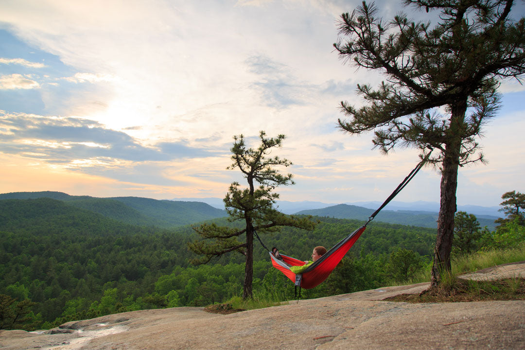 woman hanging in an ENO hammock on a plateau