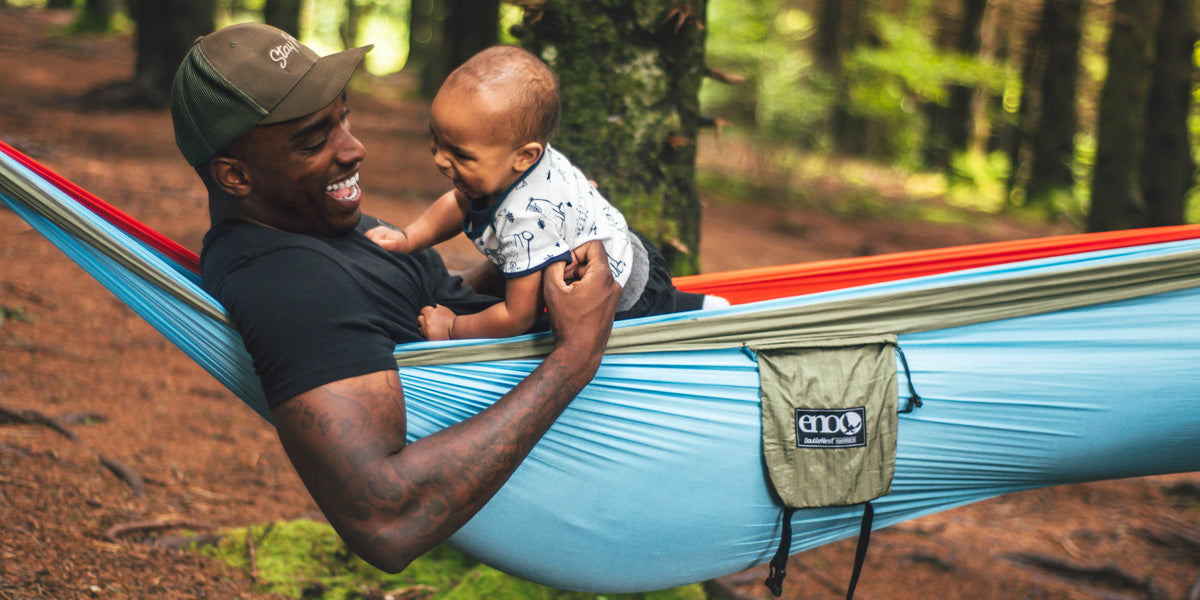 dad relaxing with his baby in hammock