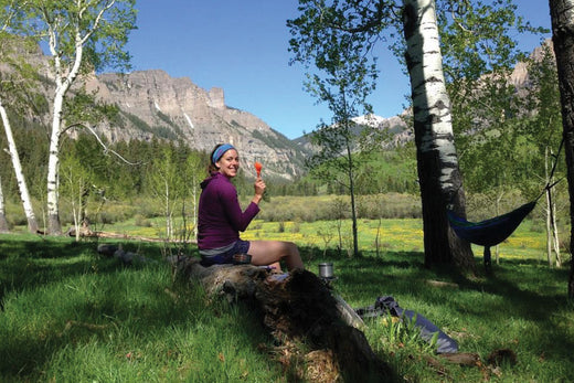 hiker cooking lunch in a meadow