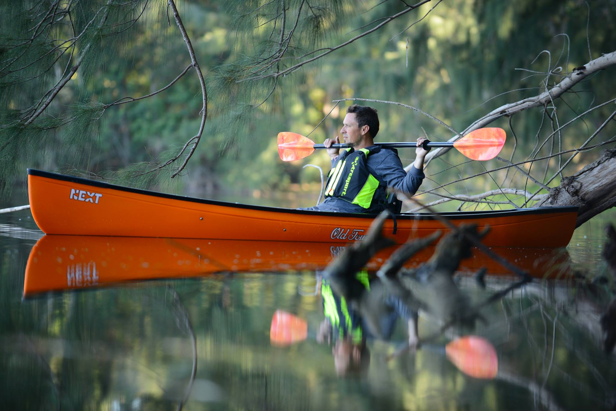 man kayaking on a river