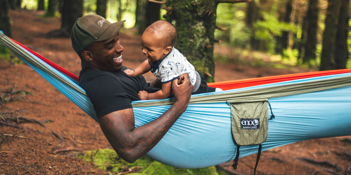 A man and a toddler in an ENO hammock