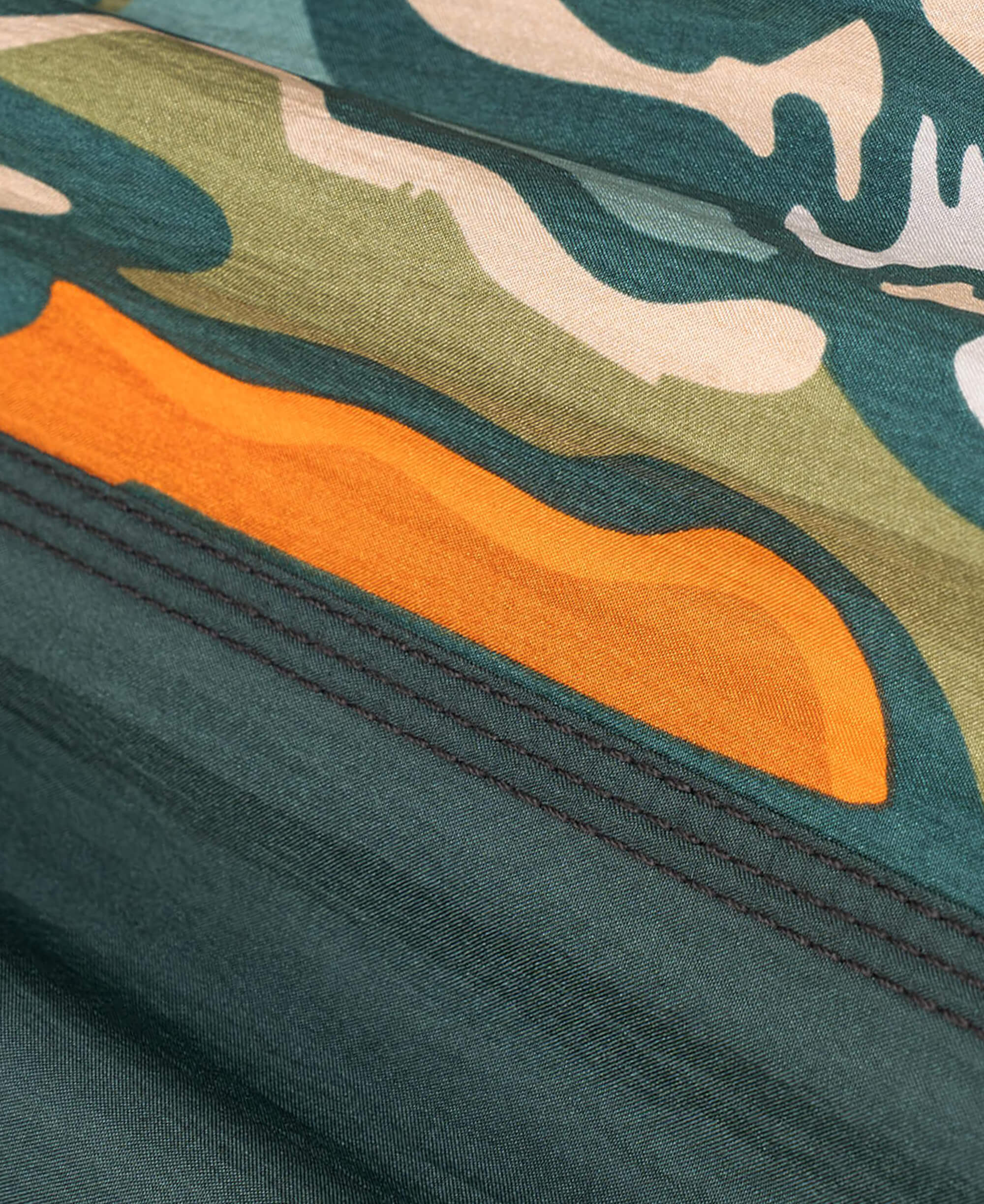 Close-up of a Giving Back Hammock Pattern fabric with an orange accent