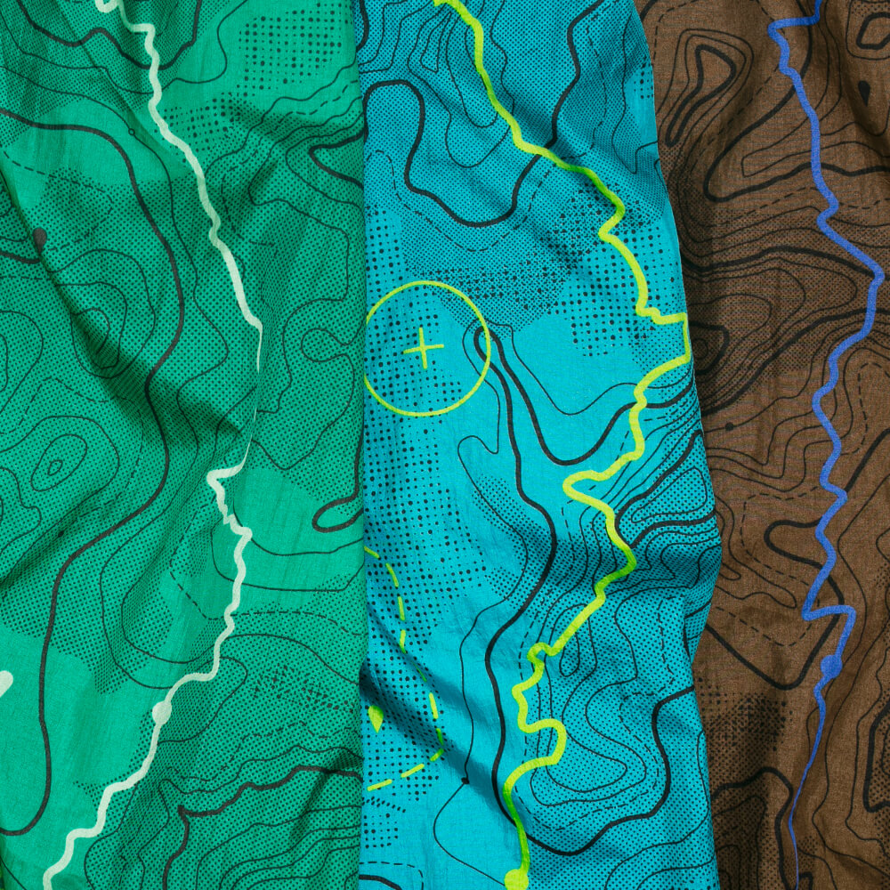 Detail of three ENO giving back hammock map prints in different colors green, blue, and brown.