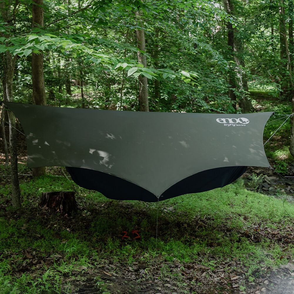 ENO rain tarp setup in lush wooded forest overtop of an ENO hammock.