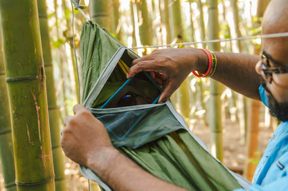 Person showing accessory pocket of ENO JungleNest™ Hammock